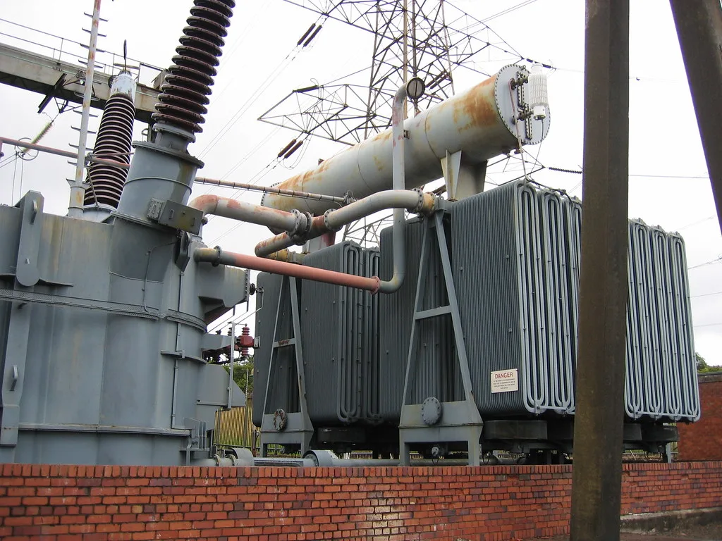 Oil-filled substation transformer with conservator tank, pipework and radiators